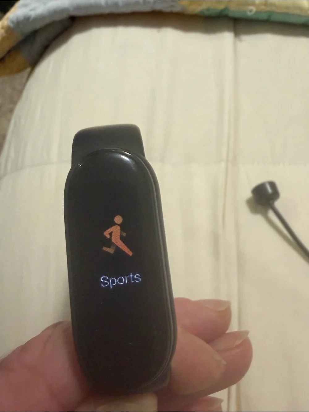 black Xiaomi Mi Band fitness tracker, model 6 or similar,
